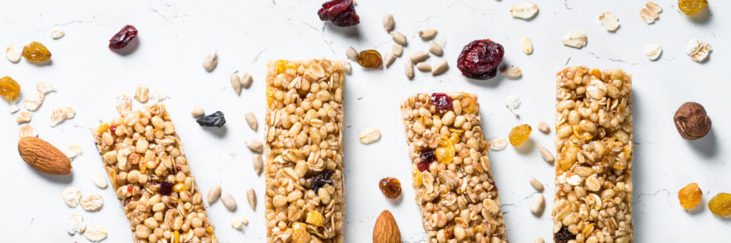 Close-up: four granola bars as snacks with natural ingredients