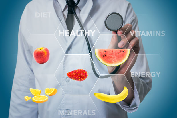 Scientist with stethoscope and various fruits