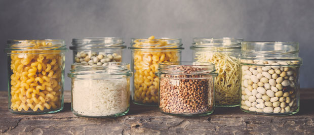 Storage jars filled with pasta, rice, beans, lentils