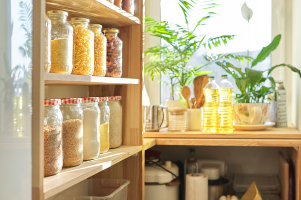 Wooden shelf with jars filled with cereal and pasta