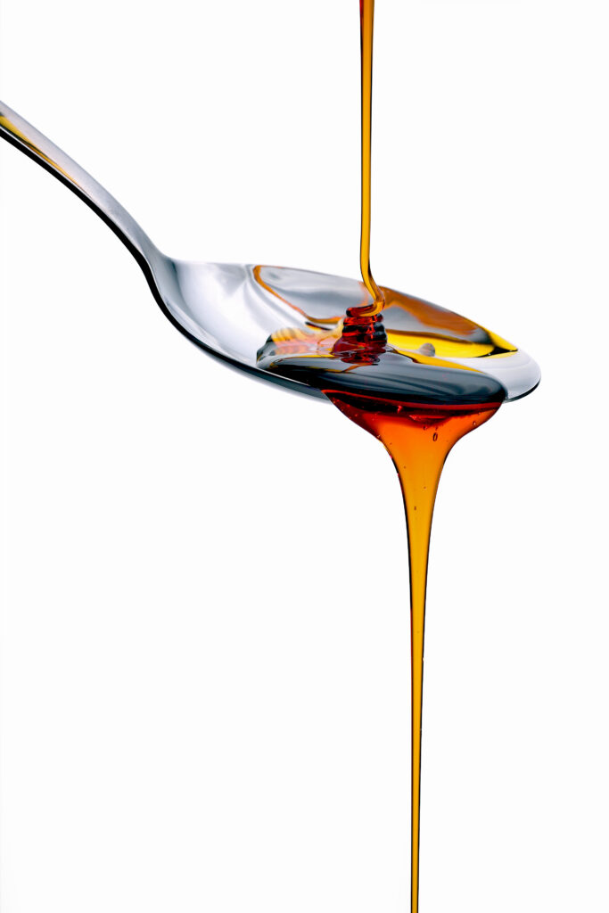 Sugar Liquid honey runs off the spoon