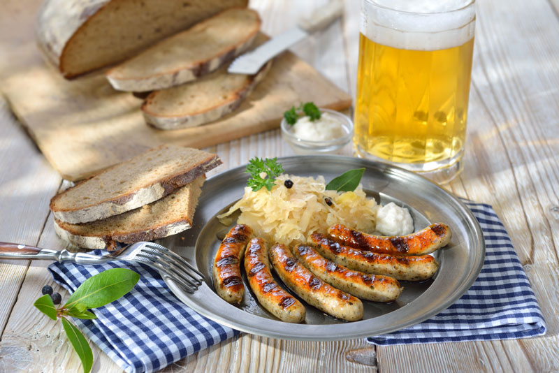 Grilled sausage with pickled cabbage, horseradish, farmhouse bread and a glass of beer