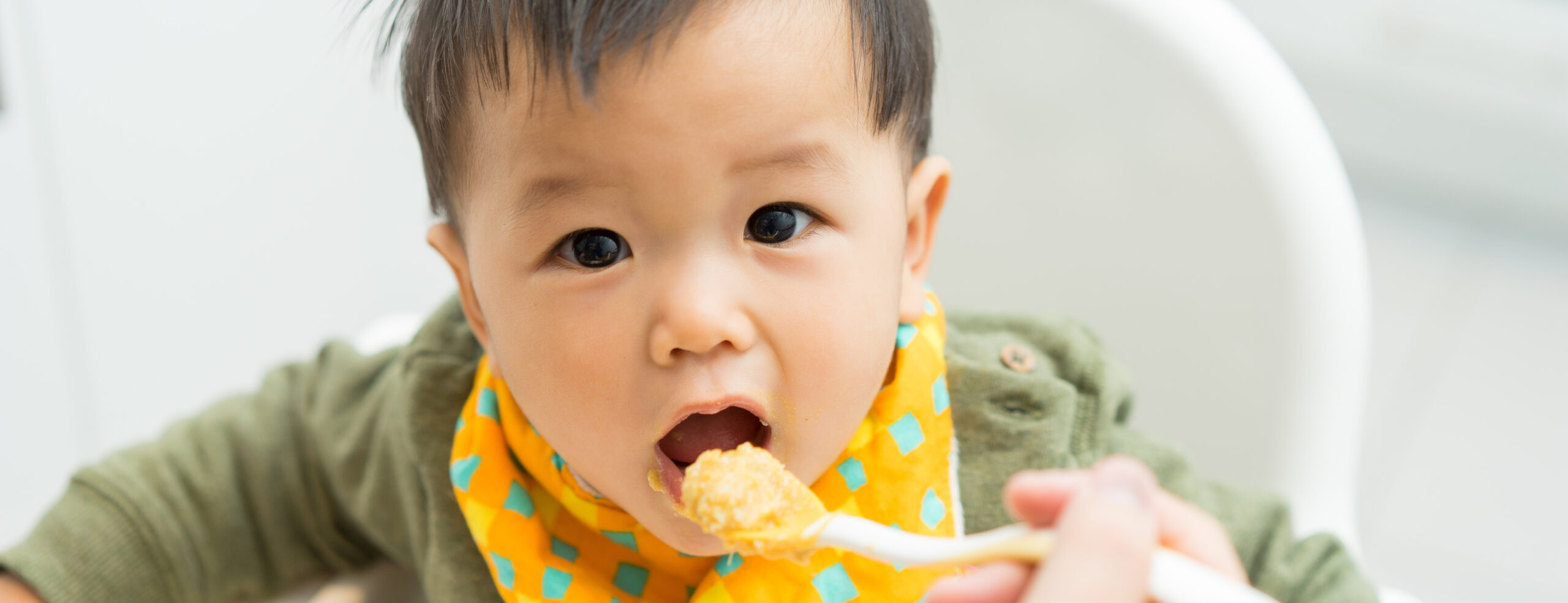 Child being fed with porridge as an image for child nutrition