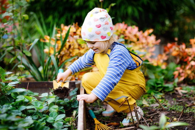 Little child working in the garden