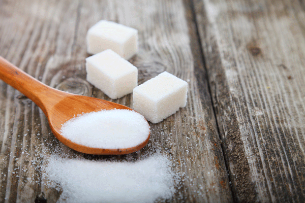 blog Sugar cubes and spoon with white sugar