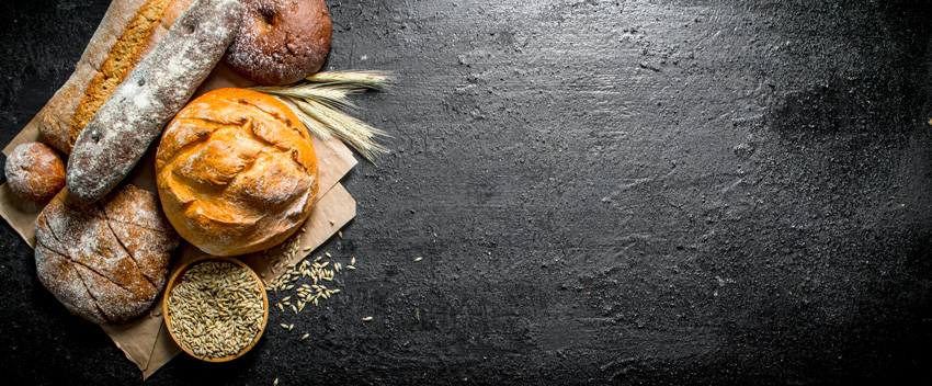 various types of bread on black background