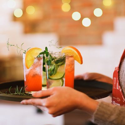 Tray with cocktails carried by a waitress